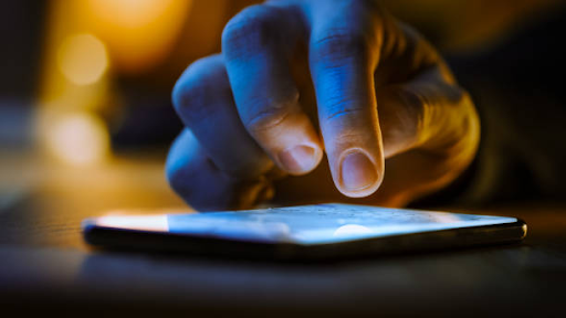 A hand interacting with a smartphone screen, highlighting the importance of mobile apps for business development.